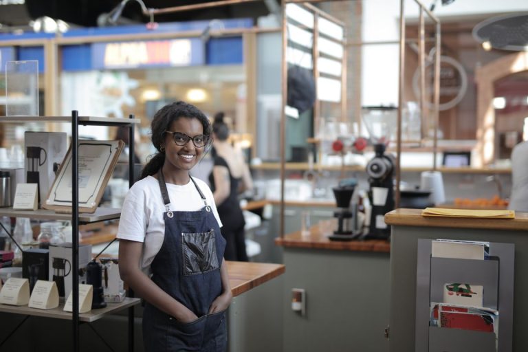 Café owner standing behind her counter